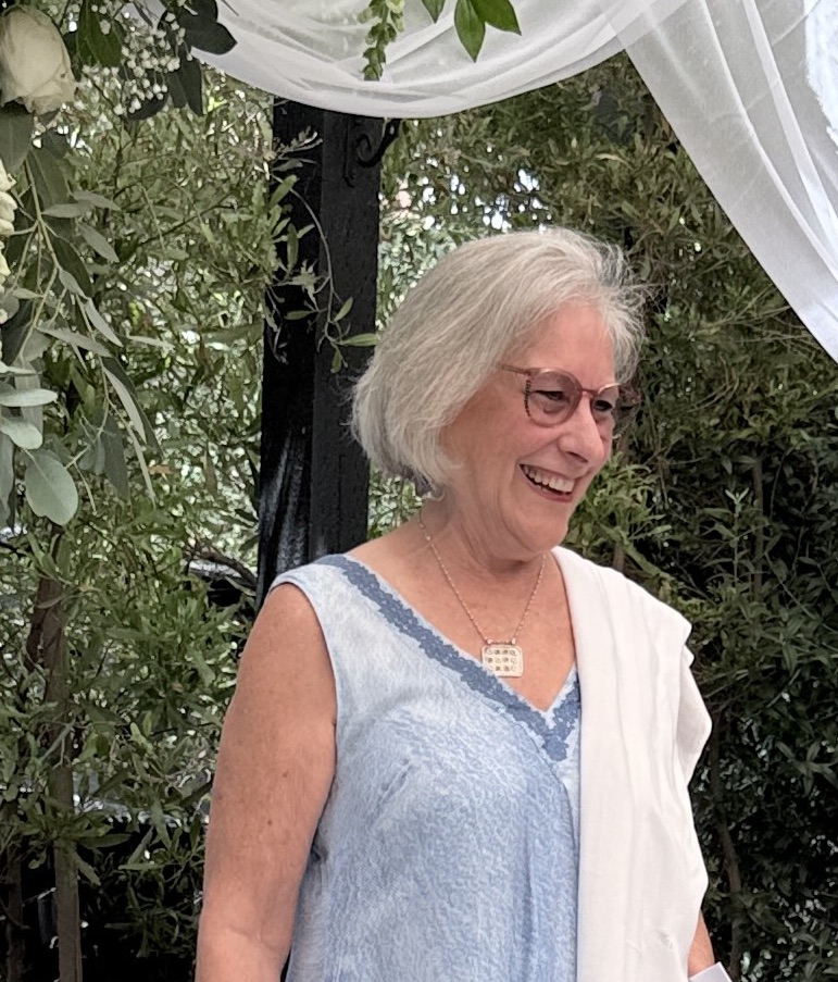 Illana smiling beneath a ceremony canopy